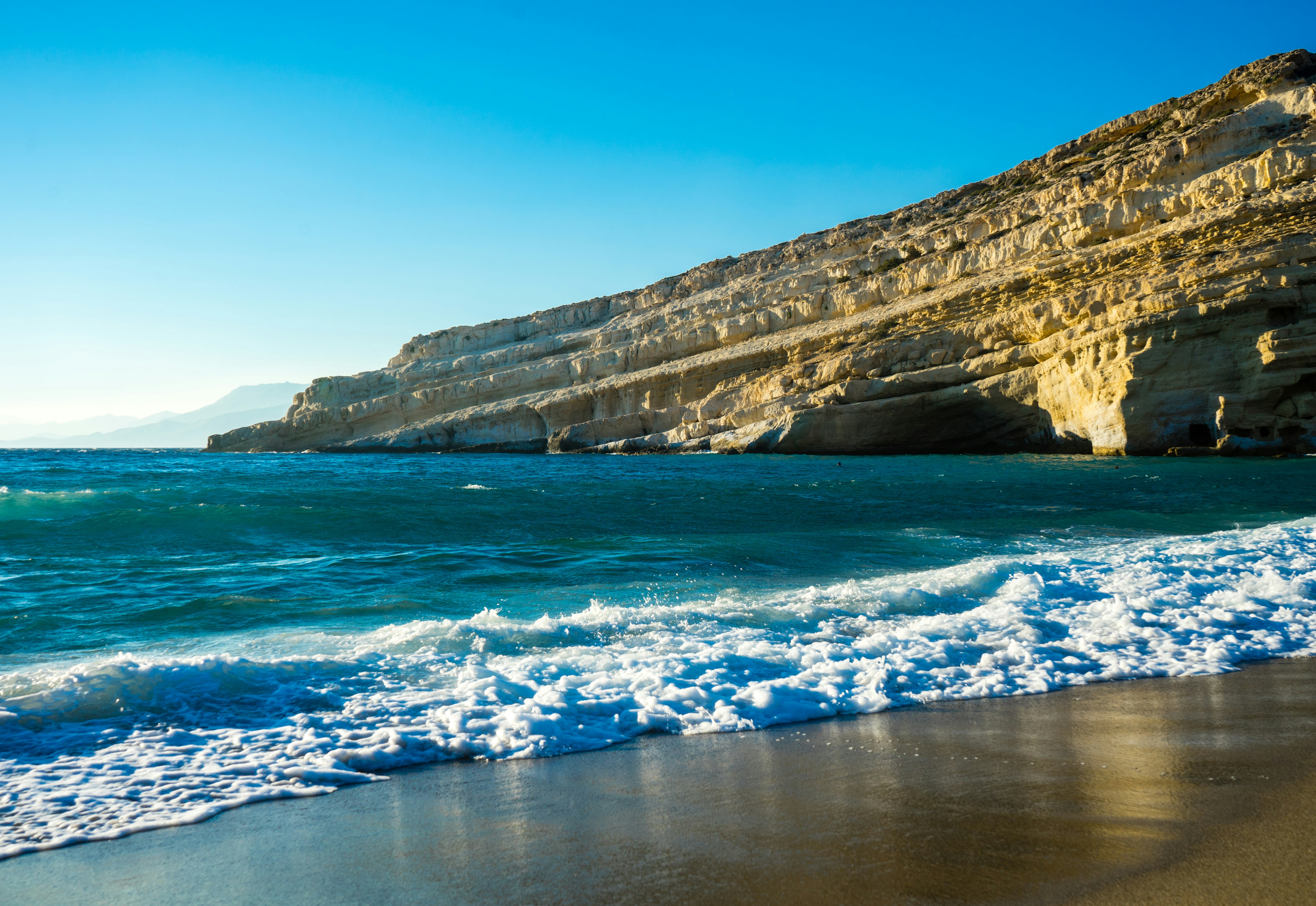 brown rock formation on blue sea water during daytime